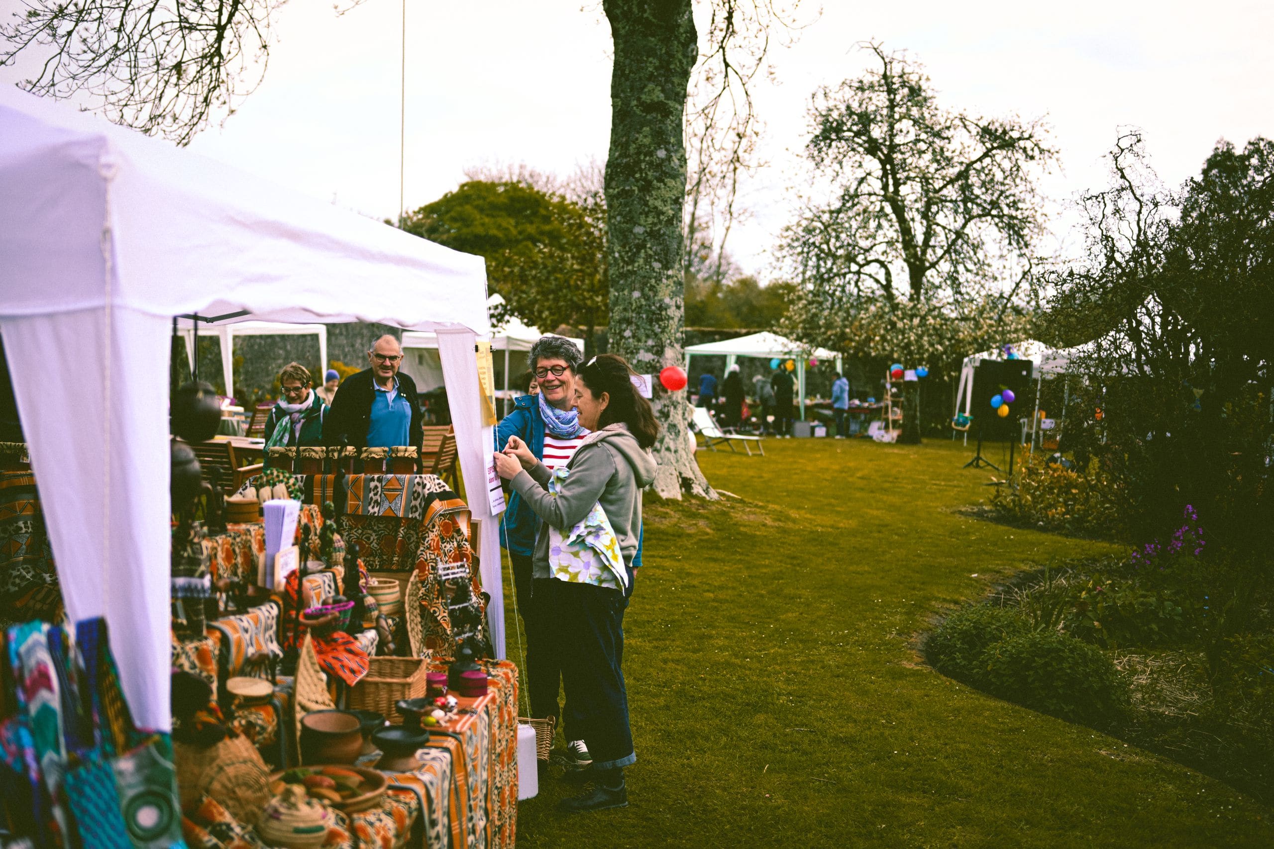 Community members of many ages and backgrounds gathered together at an outdoor education fair